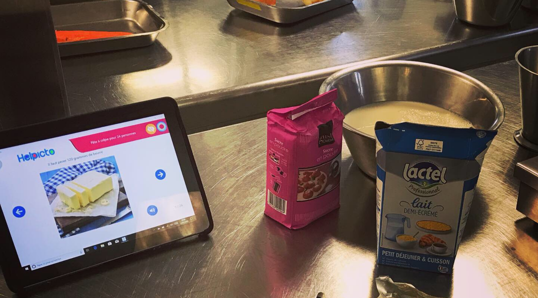 Tablet steht auf dem Tisch. Daneben eine Schüssel mit Inhalt und Zutaten.